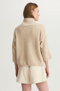 Back view of model wearing Melissa Nepton Ella Sweater in taupe with visible texture and relaxed sleeve.