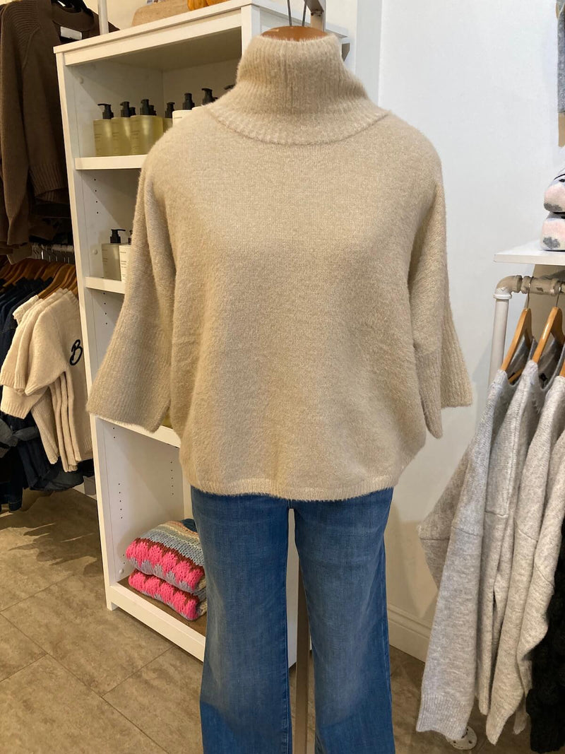 Front of taupe Melissa Nepton Ella Sweater shown in boutique with wide-leg jeans, styled casually.