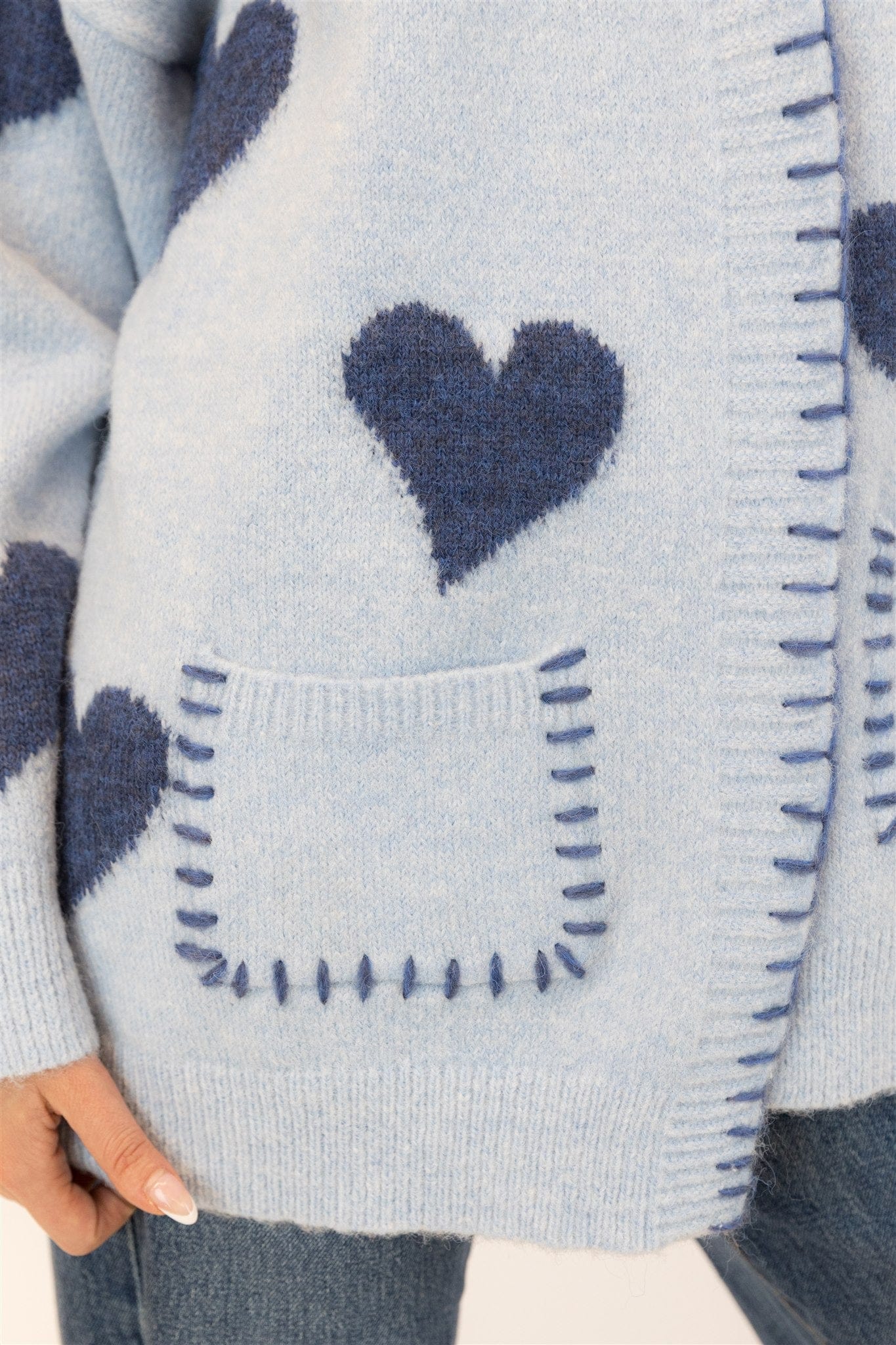 Close-up of the heart motif and pocket whipstitch details