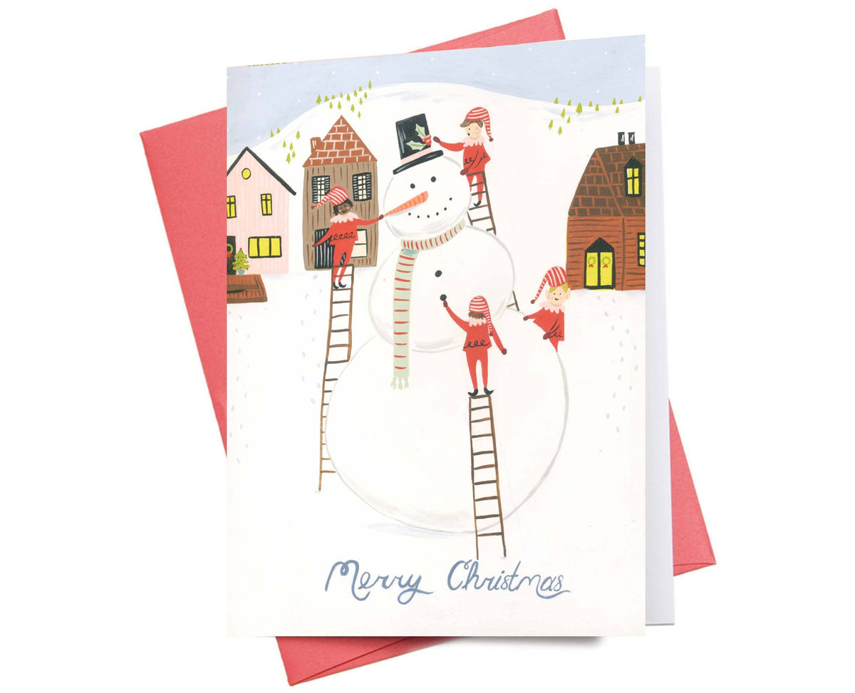 Elves Merry Christmas Card with playful snowman and houses illustration, eco-friendly Canadian-made design