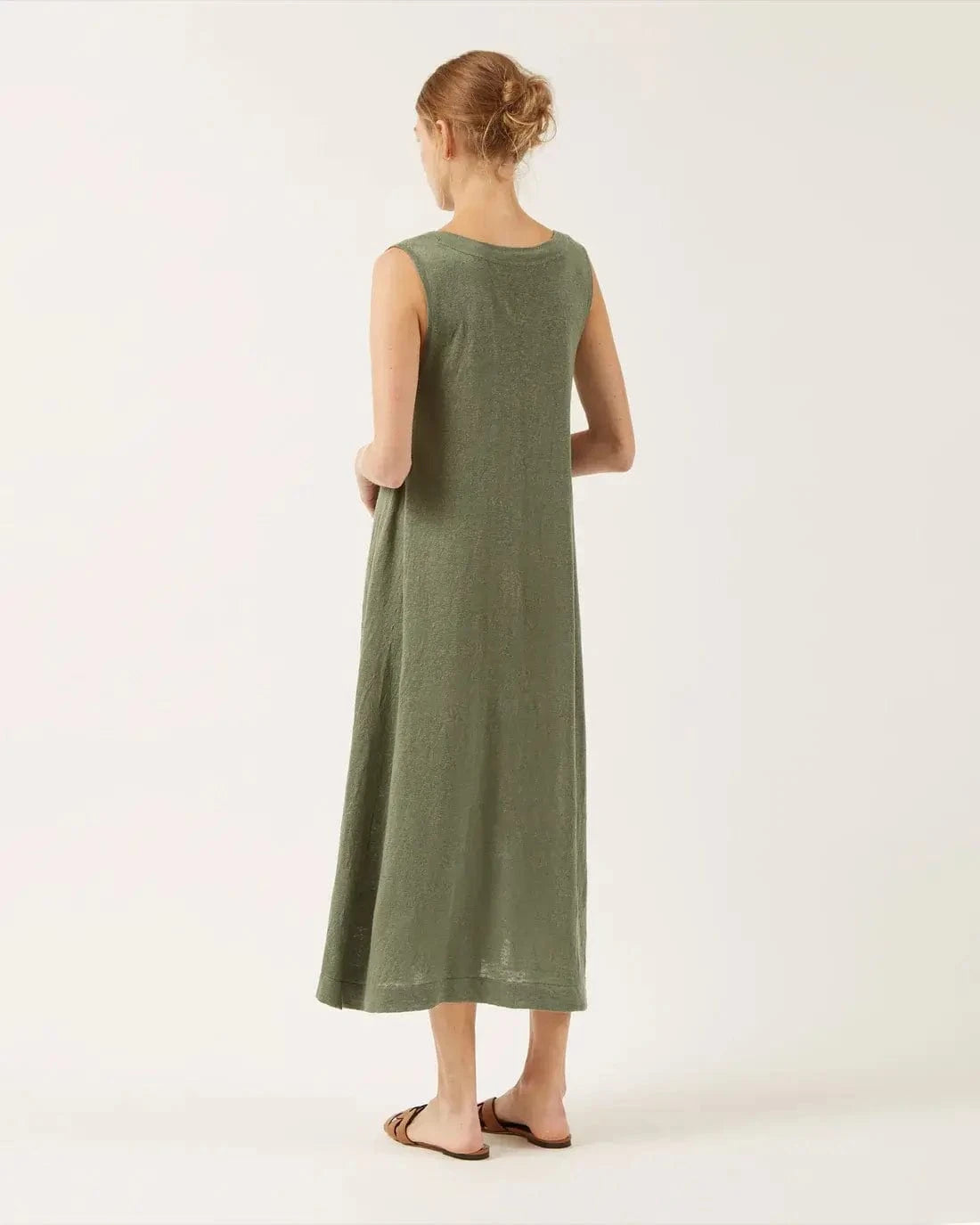 Model wearing the Erya dress by Naif, showing the back of the dress.