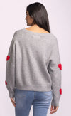Back of Espera Sweater in grey with heart appliqués on sleeves and ribbed hem