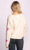 Back view of Espera Sweater in white showing heart appliqués on sleeves