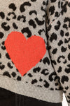 Close-up of front patch pocket and heart design with whipstitch trim
