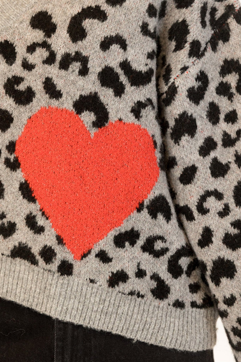 Close-up of front patch pocket and heart design with whipstitch trim