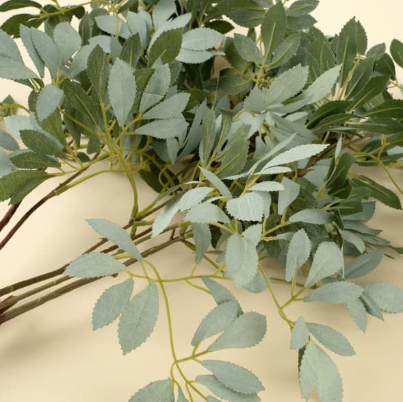 Close-up of faux olive leaf branch showing realistic leaf shape and muted green tones, Lemonberry Aurora