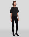 Full front pic of a model wearing the black skinnys from 7FAM paired with a black tee.