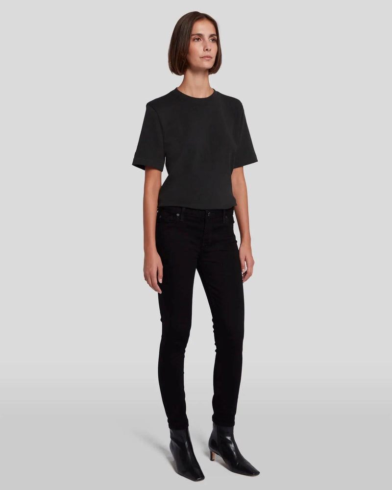 Full front pic of a model wearing the black skinnys from 7FAM paired with a black tee.