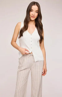 Close up of the Findley Pant by Gentle Fawn displaying the linen texture, pin stripe pattern and cute bow tie on the front.
