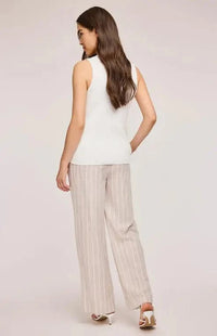 Back view of the Findley Pant by Gentle Fawn, worn by a model in a white vest and white open toe shoes.
