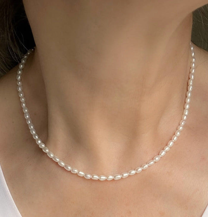 Petite pearl necklace worn on neck, Luna, worn view — Lemonberry Aurora