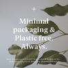Minimal packaging & plastic free text with green leaves on a gray background