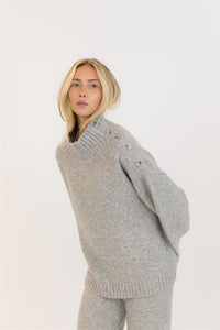 Side angle showing shoulder button detail on GANTLUXE sweater
