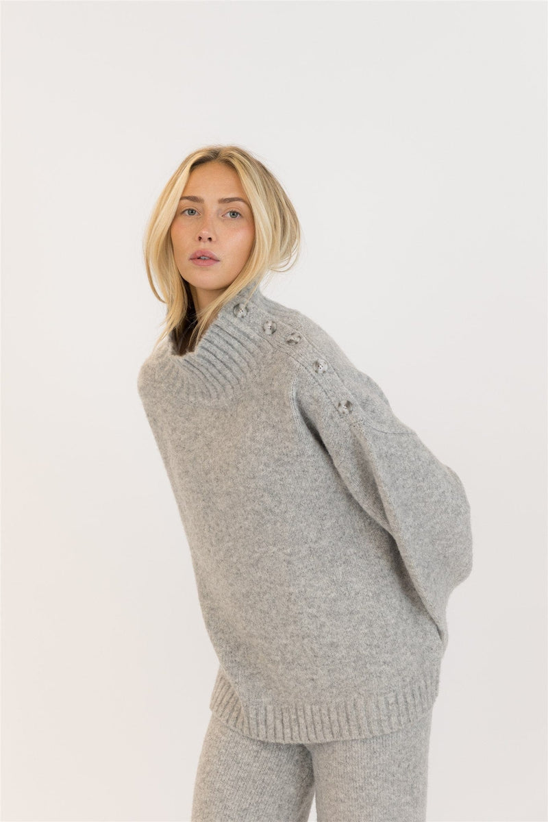 Side angle showing shoulder button detail on GANTLUXE sweater