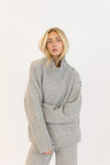 Front view of woman in GANTLUXE Heather Grey sweater and pants set, studio background