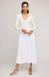 Gentle Fawn Geneva skirt in white, paired with white strappy shoes.