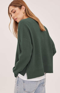 Back view of the Gentle Fawn Axel sweater in Aspen showing the centre seam and side-slit hem