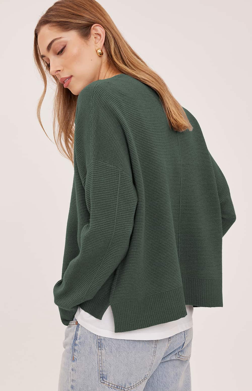 Back view of the Gentle Fawn Axel sweater in Aspen showing the centre seam and side-slit hem