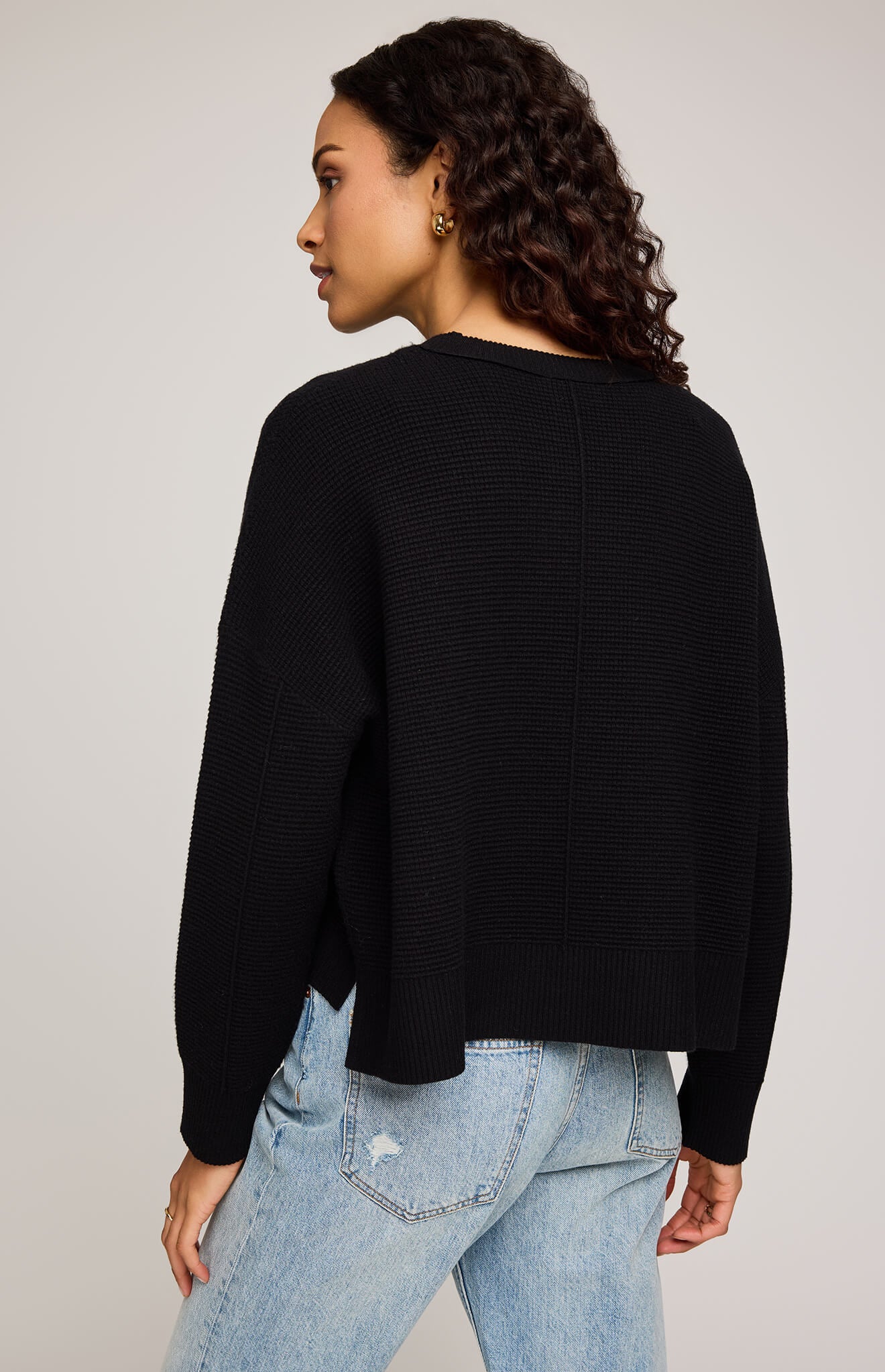 Back view of Gentle Fawn Axel Sweater in black, showing seam detail and relaxed cropped fit.