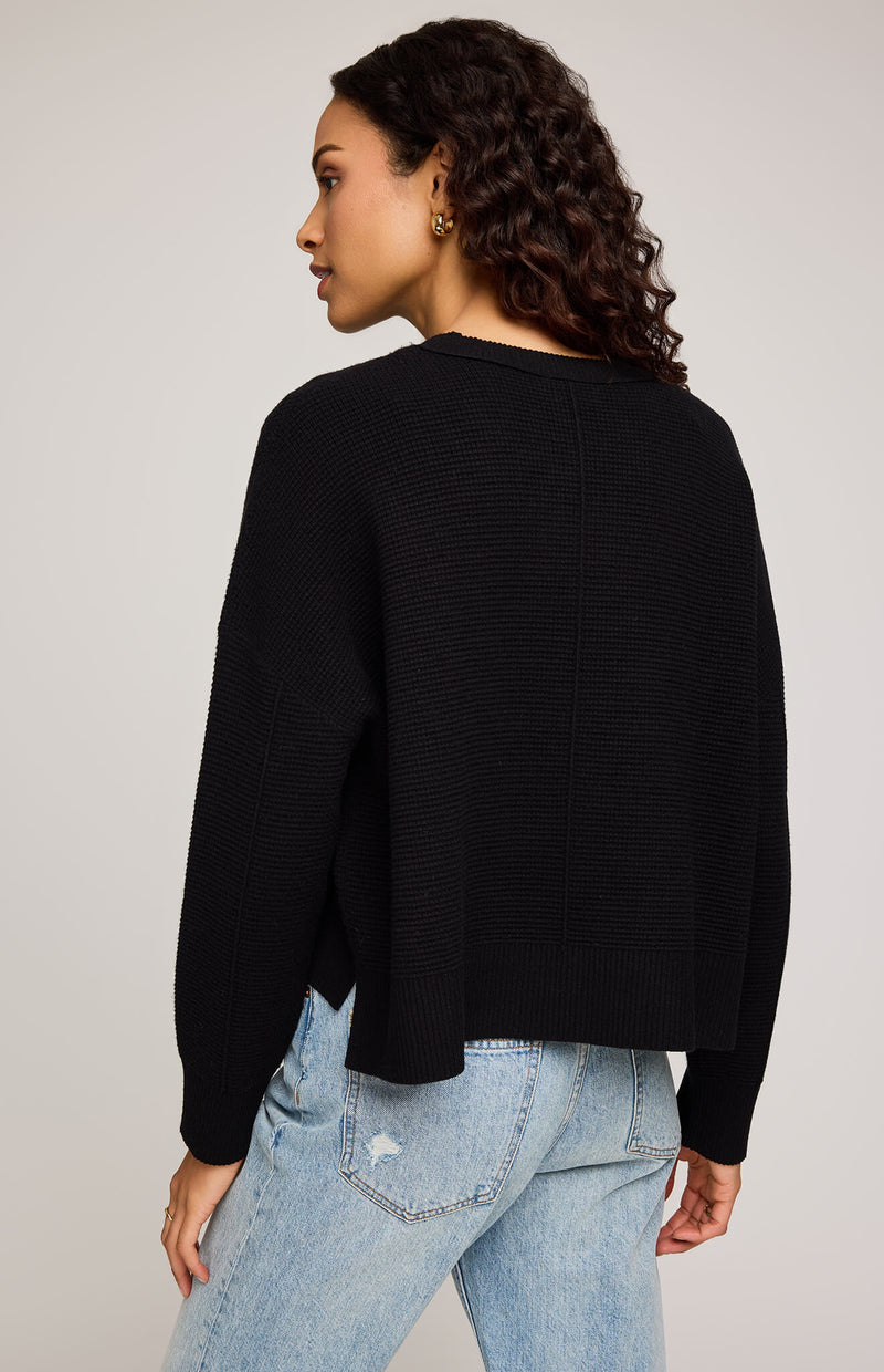 Back view of Gentle Fawn Axel Sweater in black, showing seam detail and relaxed cropped fit.