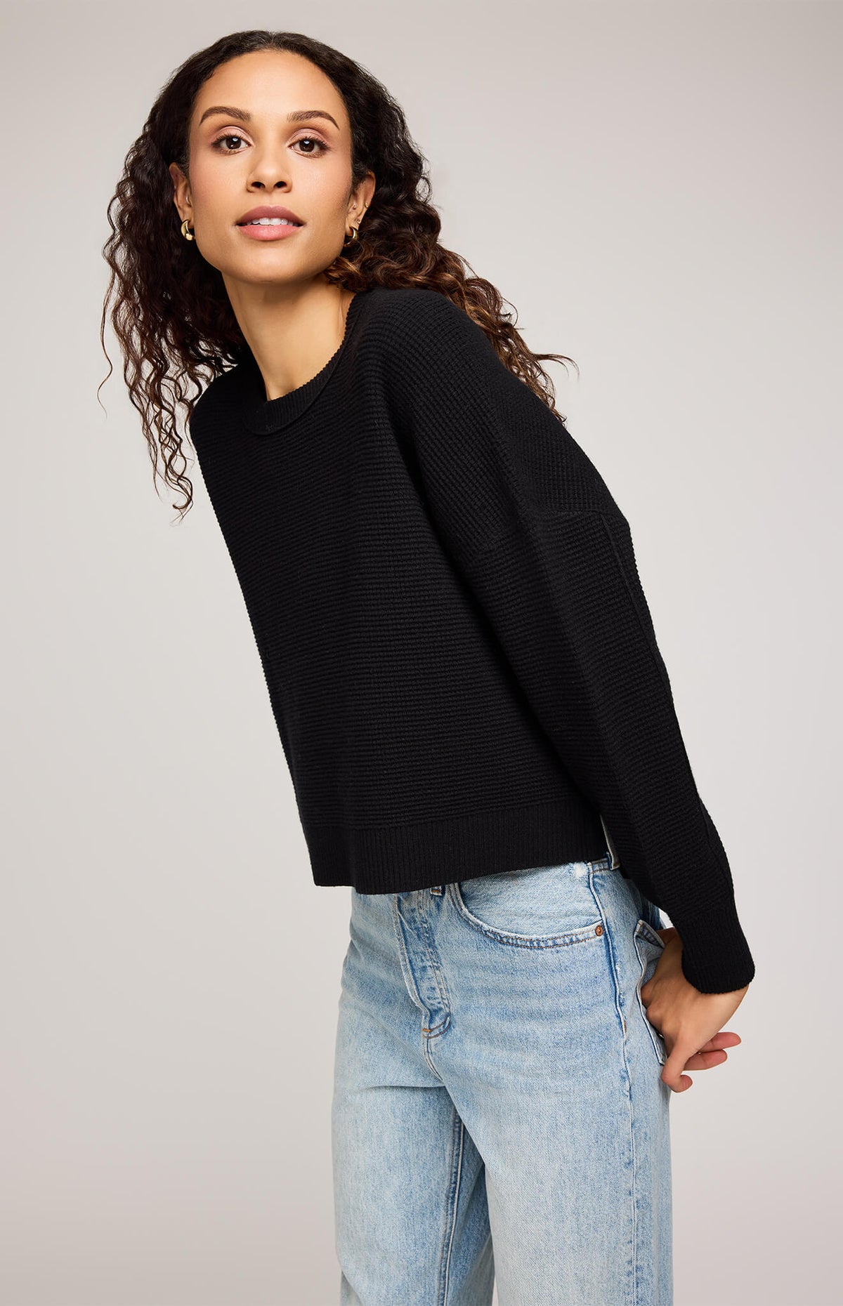 Close-up of Gentle Fawn Axel Sweater in black showing waffle knit texture and crew neckline.