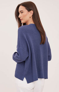 Back view of the Gentle Fawn Axel sweater in Heather Navy showing its textured knit and side slits