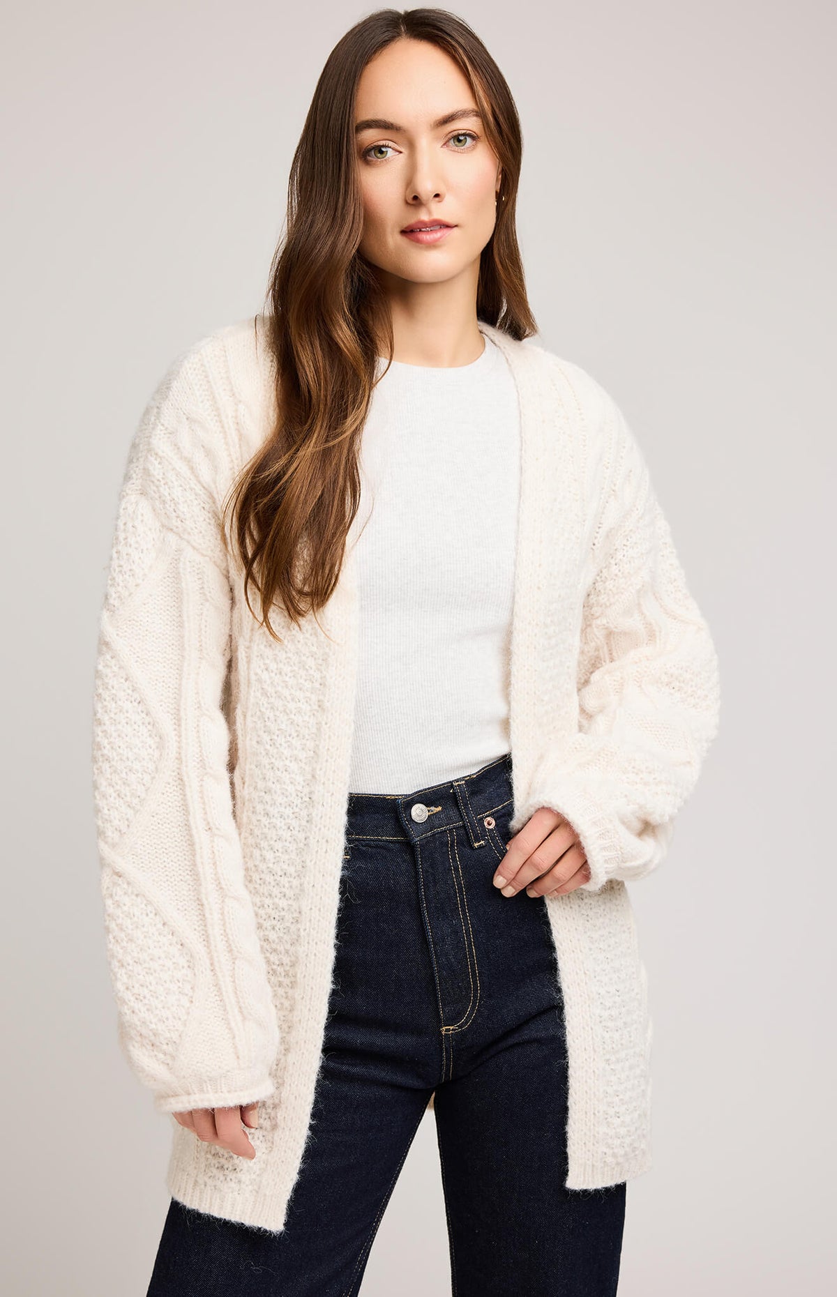 Close-up of Gentle Fawn Betty Cardigan in cream showing cable knit detail and rolled sleeve hem.