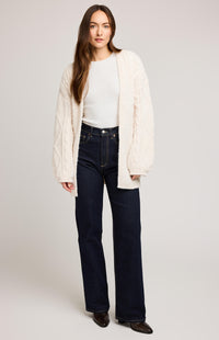 Front view of model wearing Gentle Fawn Betty Cardigan in cream, styled with dark denim, photographed on neutral background – Barrie Waterfront reference.