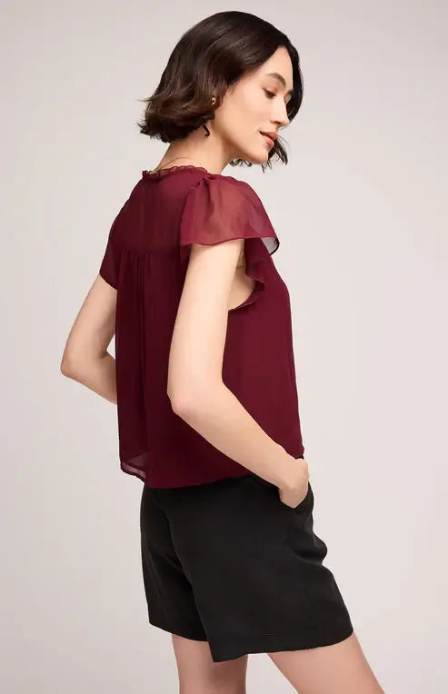 Side view of Gentle Fawn Carlotta blouse in rich wine colour, close-up of neckline
