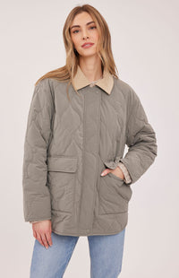 Closed front view of the Gentle Fawn Felix quilted jacket in Mineral showing its pockets and snap placket