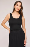 Model wearing the Gentle Fawn Layla Tank in black, front view. Features a smocked bodice, scoop neckline, and ruffled hem.