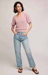 Soft pink Phoebe sweater with puff sleeves styled casually for everyday wear – side view