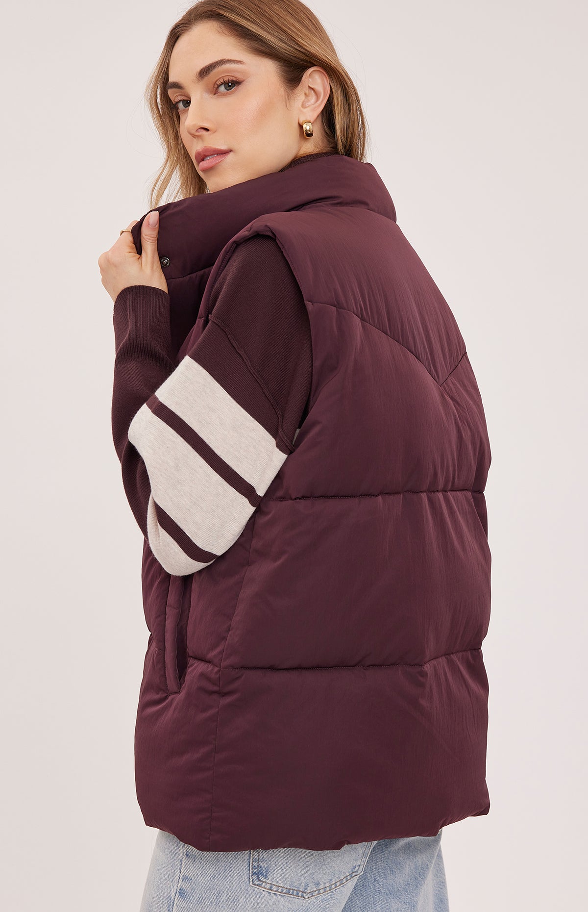 Back view of the Gentle Fawn Shiloh puffer vest in Fig showing its oversized fit and padded collar