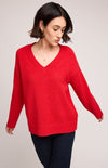 Close-up of Gentle Fawn Tilda Sweater in red showing bouclé yarn texture and v-neckline.