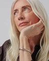 Model wearing the silver Gia bangle by Jenny Bird.