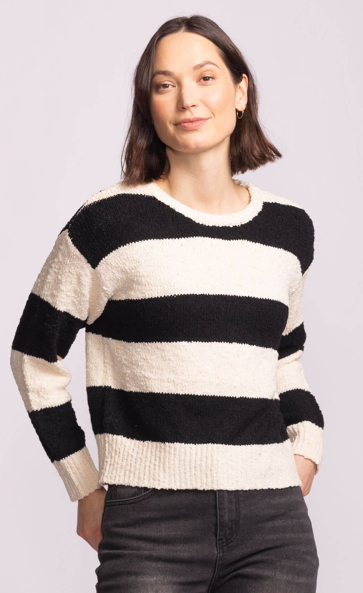 Front angled view of Pink Martini Glynn Sweater, black and white striped knit, versatile everyday Toronto fashion.