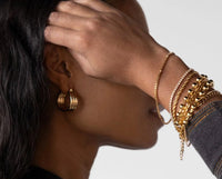 Gold stainless steel tennis bracelet layered with gold bangles and hoop earrings waterproof zircon Lemonberry Aurora