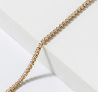 Close up of gold stainless steel tennis bracelet with round clear prong set zircon stones waterproof Lemonberry Aurora