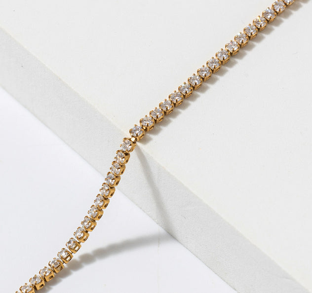 Close up of gold stainless steel tennis bracelet with round clear prong set zircon stones waterproof Lemonberry Aurora