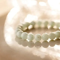 Shiny Soul Creations Angelite Bracelet in soft green photographed with sparkling light reflection