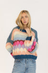 Front view of woman wearing handmade multi-stripe Lyla + Luxe HANNAH sweater with relaxed jeans in studio


