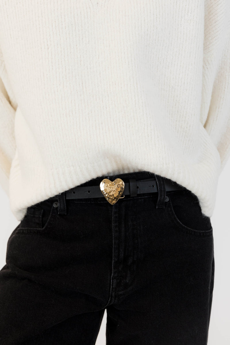Black Lyla & Luxe belt with hammered gold heart buckle, styled with cream sweater and black denim, photographed near Lemonberry.