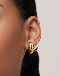 Single gold heart button earring by Jenny Bird, detail view — Lemonberry Aurora