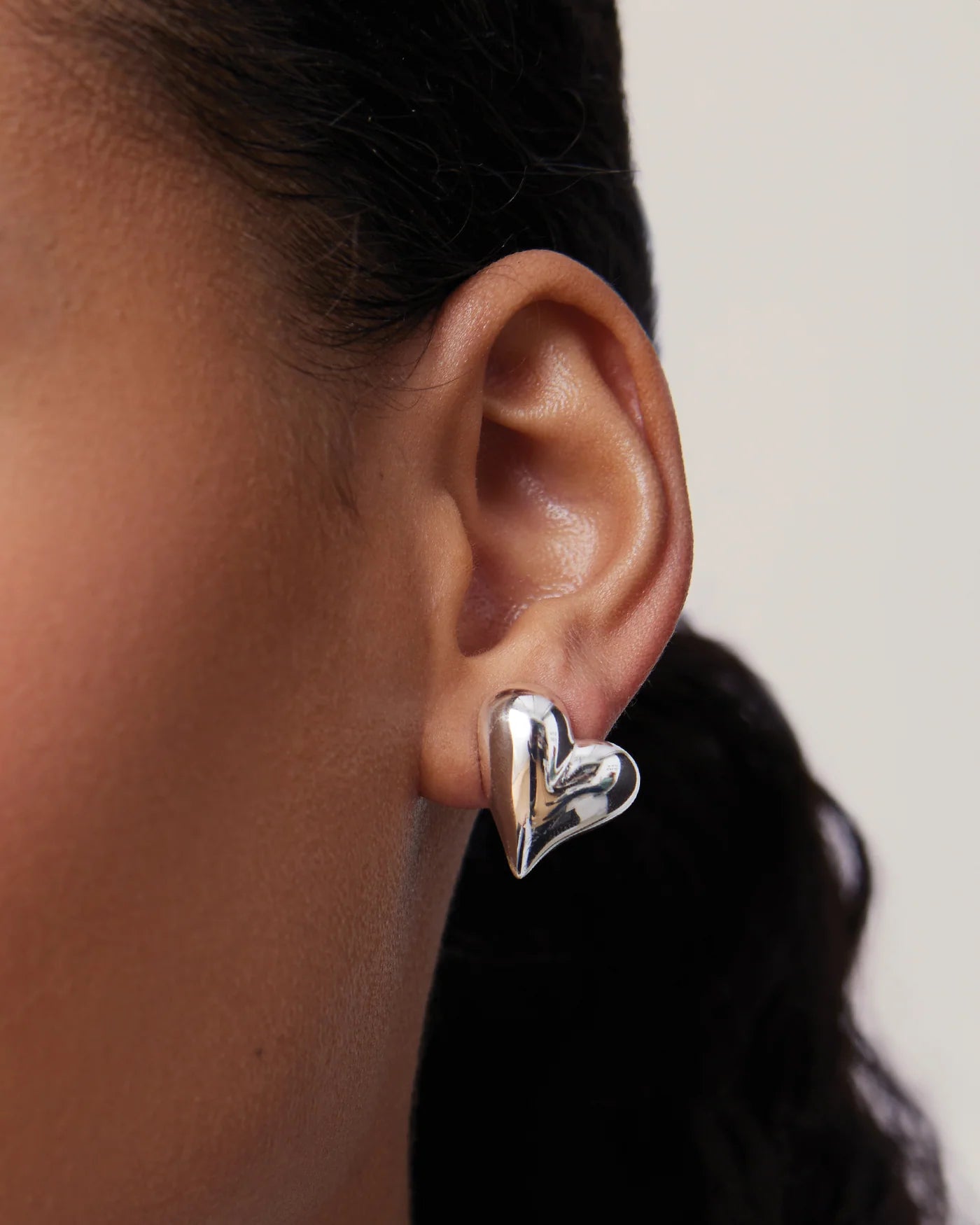 Angled view of silver heart button earrings by Jenny Bird — Lemonberry Aurora