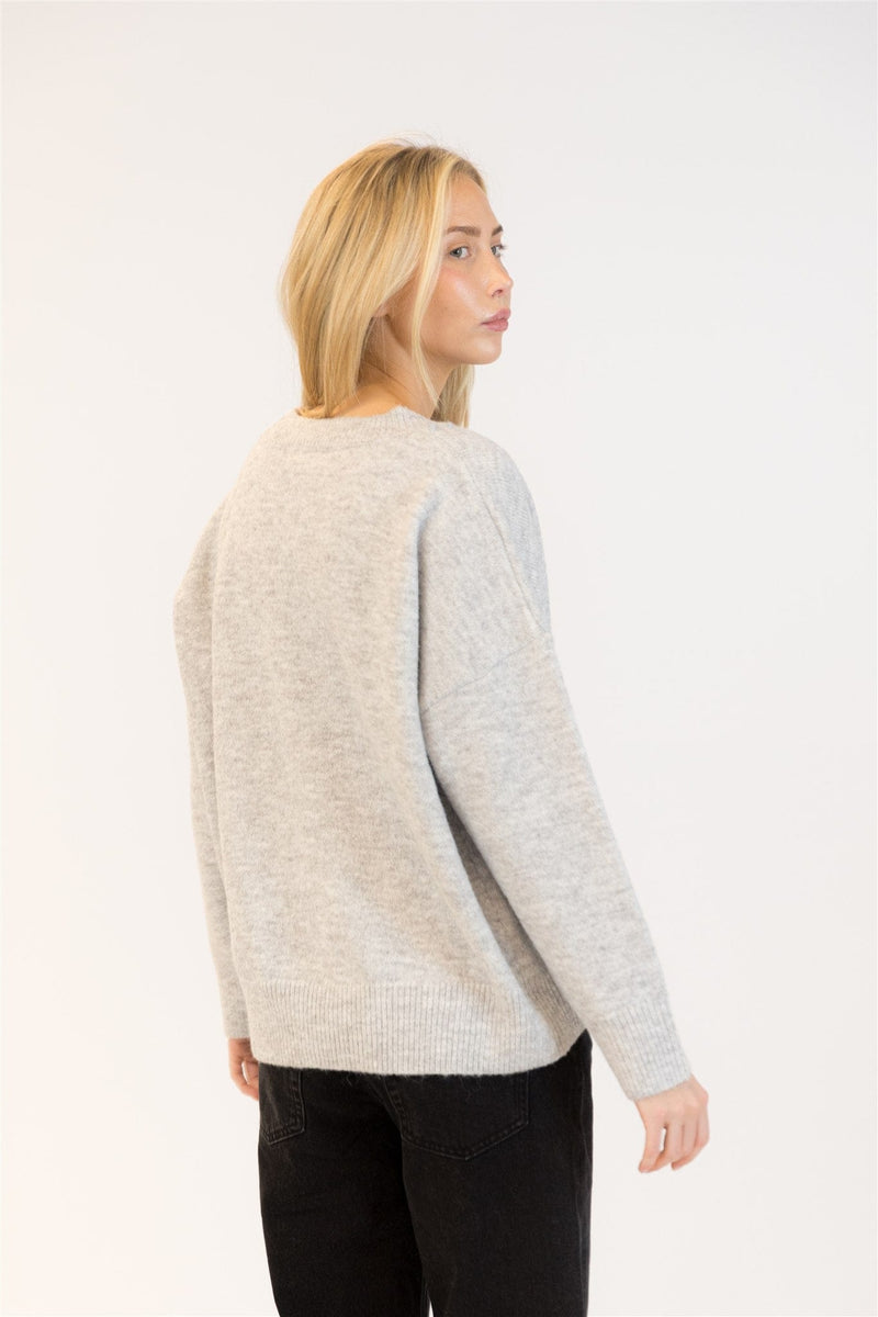 Back view of grey Lyla & Luxe sweater showing relaxed fit