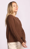 side view of Hempden brown sweater showing relaxed raglan sleeves and knit texture