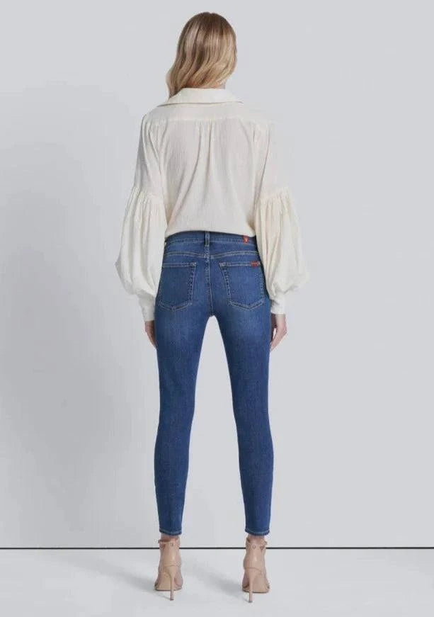 Full back view of high-waisted skinny jeans in a medium wash, featuring a flattering fit and classic back pockets.