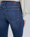 Close-up of back pocket detail on high-waisted skinny jeans, showing signature stitching and soft stretch denim.