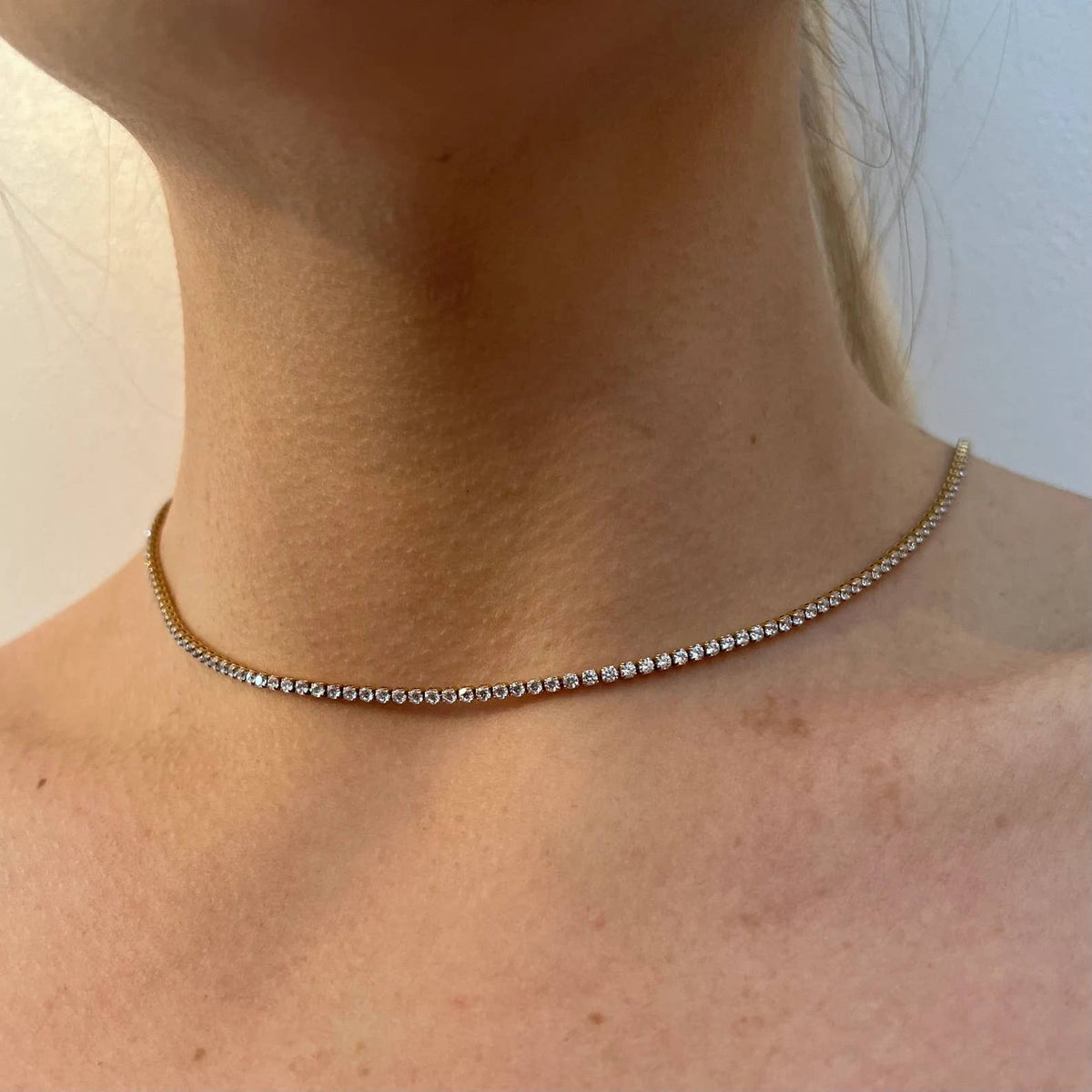 Hoopla gold tennis necklace styled as choker on model Lemonberry Aurora