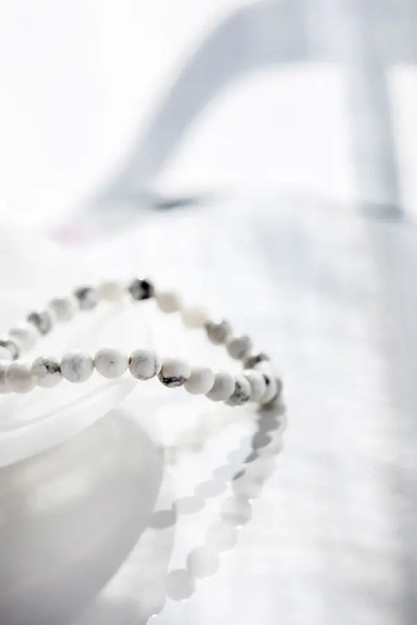 Howlite bracelet raised on glass dish, photographed with natural light at Lemonberry in Aurora, ON